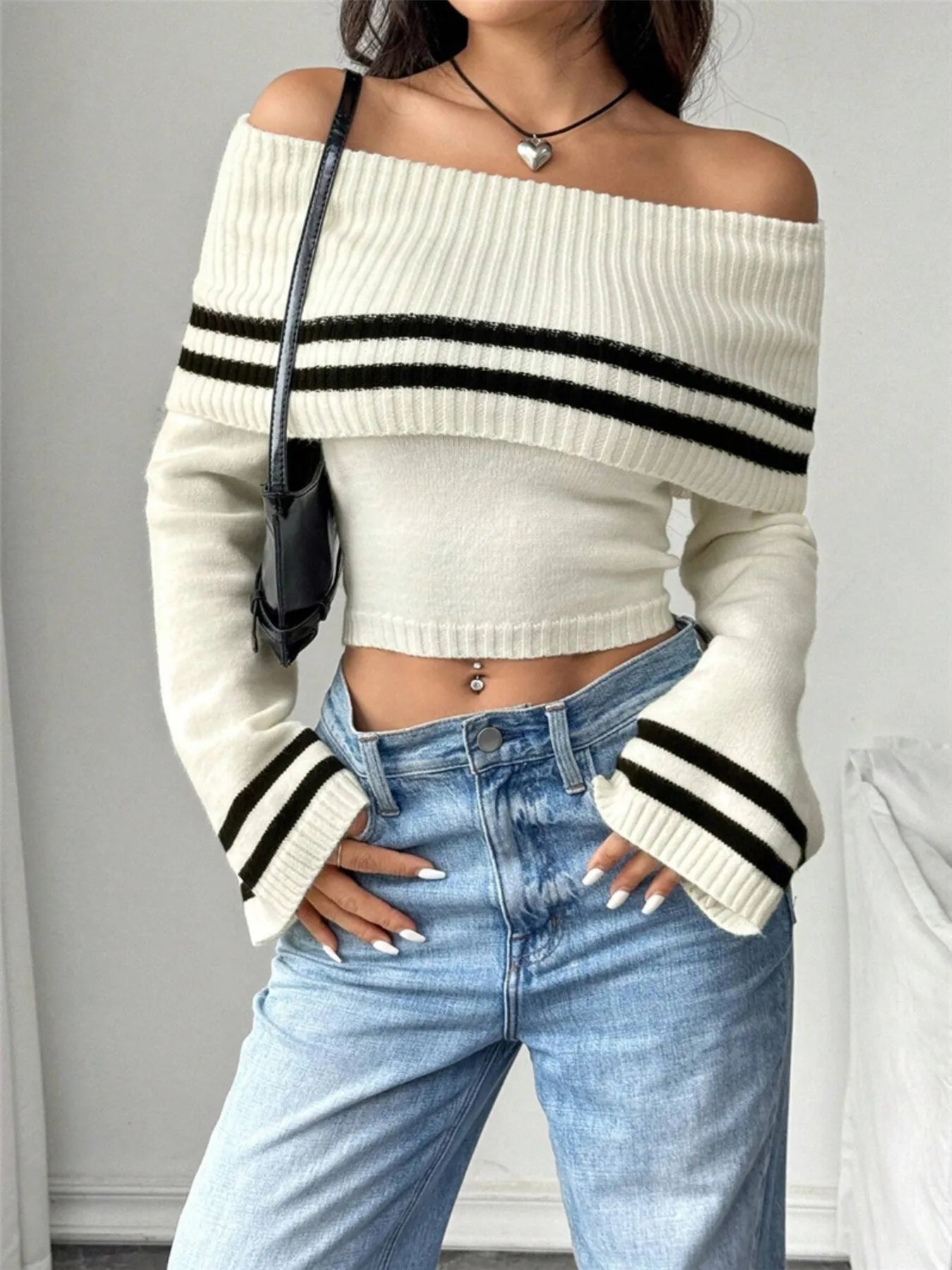 Front view of ribbed off-shoulder striped knit top