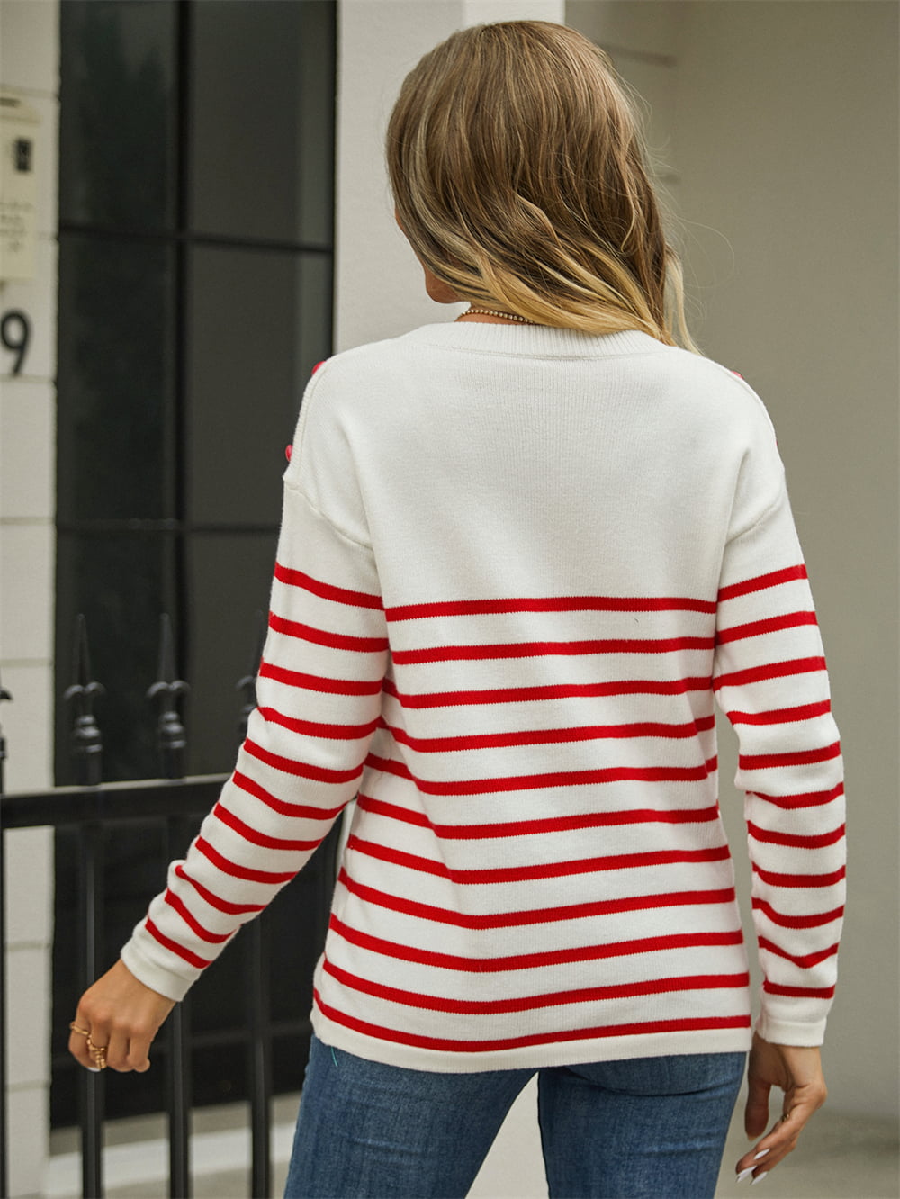 Back side of striped knit sweater with angel wings style