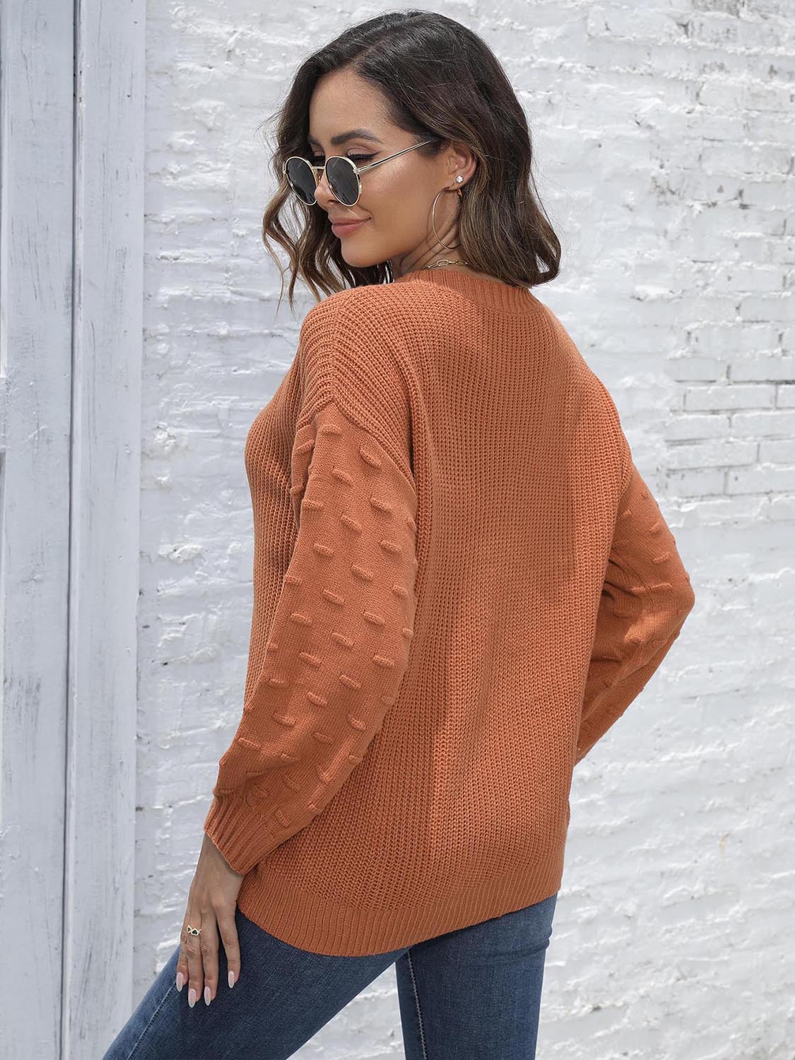 Back view of round neck dropped shoulder sweater showing loose silhouette