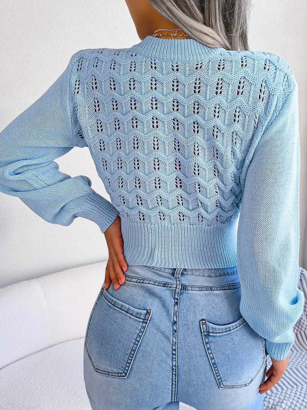 Rear view of openwork knit cropped sweater