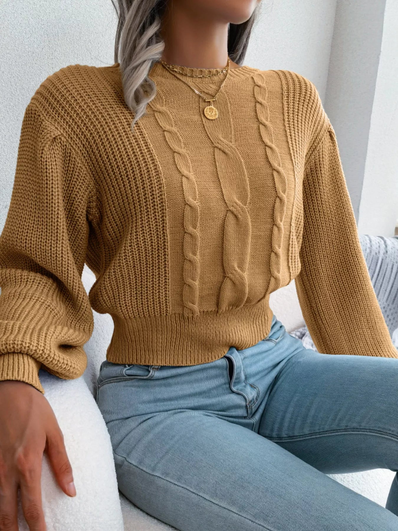 Fabric detail of cropped cable knit sweater