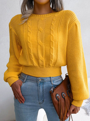Front view of cable knit round neck cropped sweater
