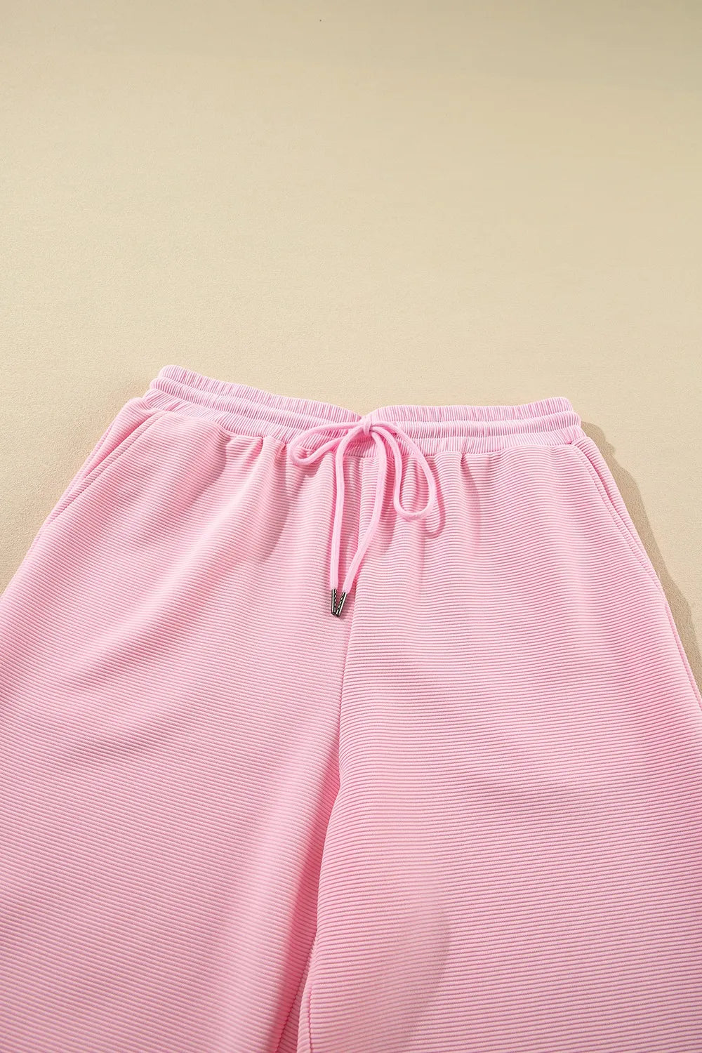 Close up of textured ruffled sleeve top and pants