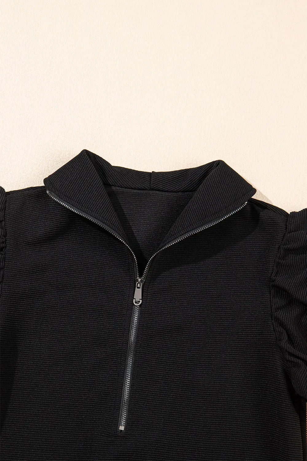 Flat display of textured ruffled sleeve top and pants