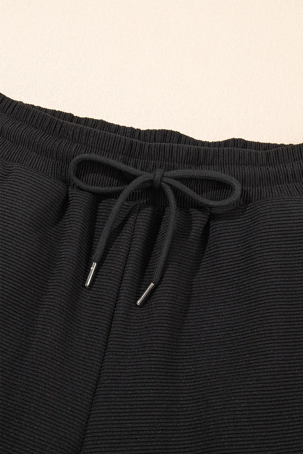 Detailed display of textured ruffled sleeve top and pants set