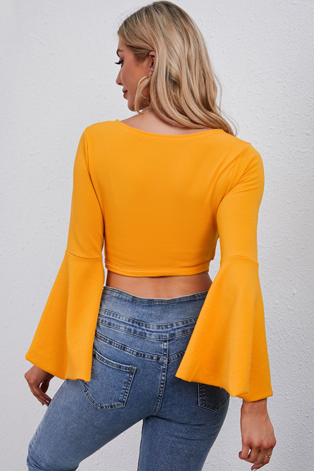 Back view of tie front flare sleeve cropped top