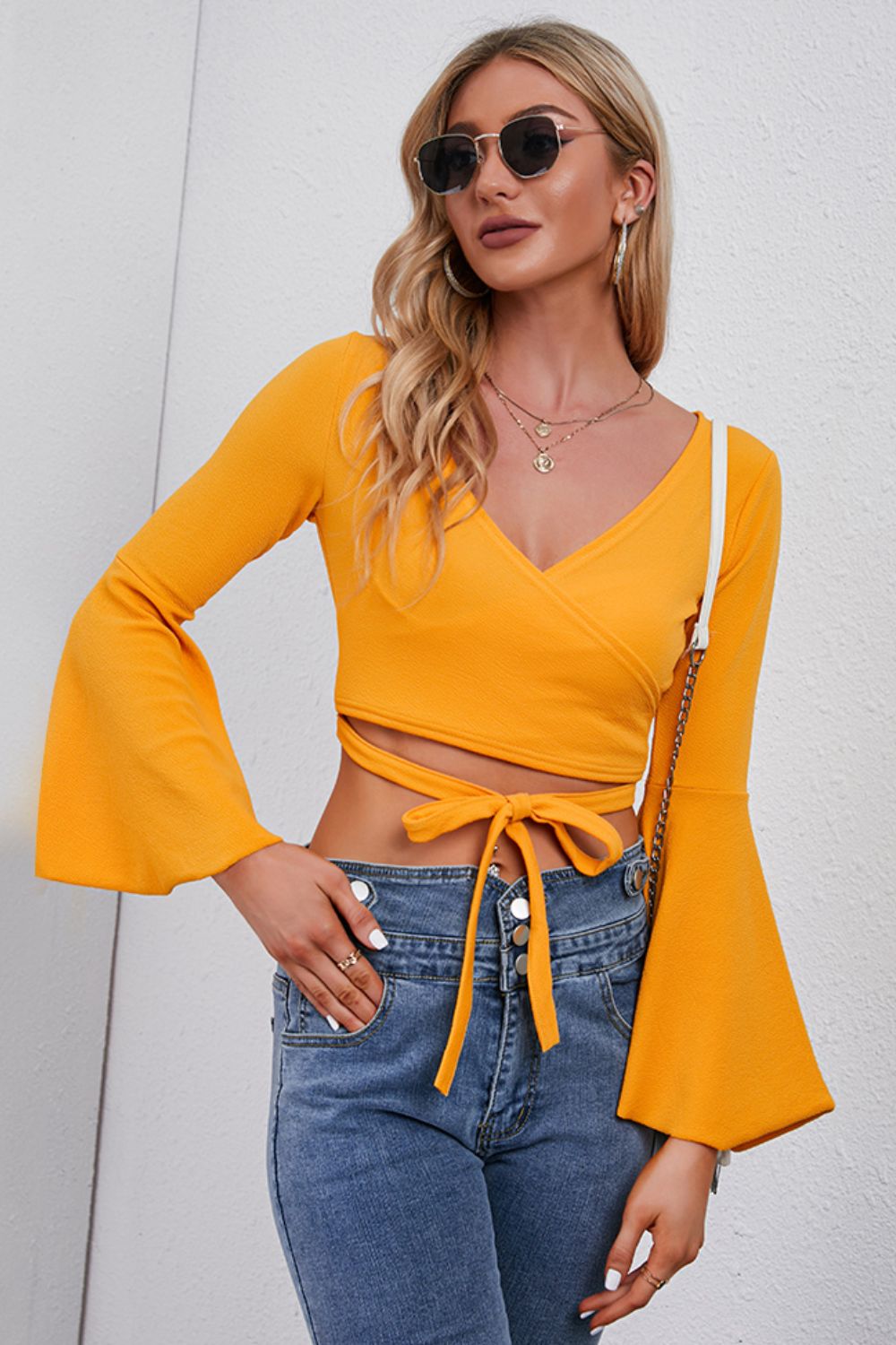 Front view of tie front flare sleeve cropped top
