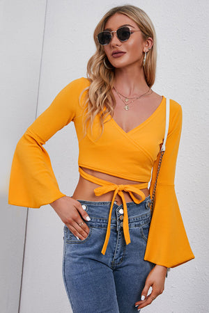 Front view of tie front flare sleeve cropped top