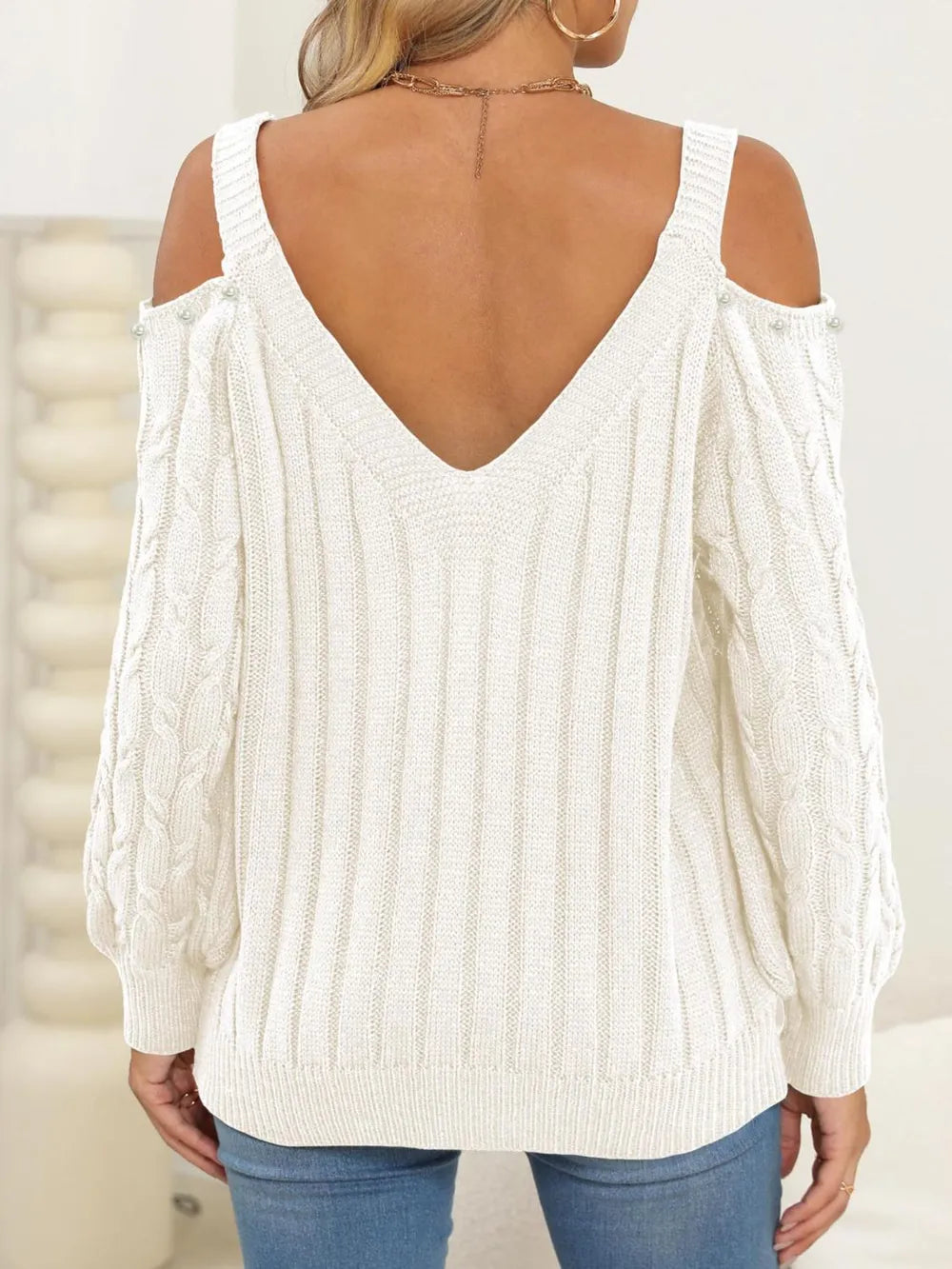 Back side of Cable-Knit Cold Shoulder Sweater with cable knit pattern