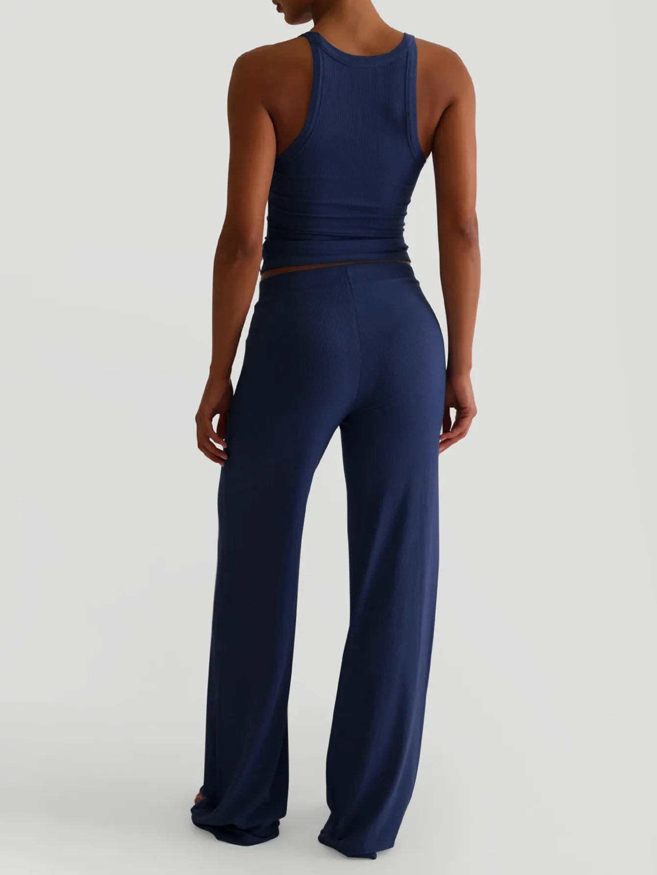 Back view showing outfit details and pants design